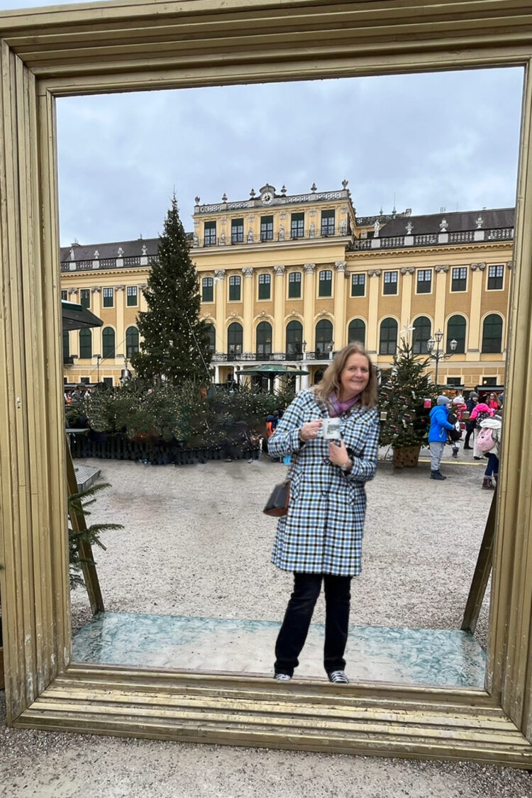 Tammy, founder of Austria Wanderlust—the Austria travel guide—on a balcony overlooking the Kitzsteinhorn glacier in Austria