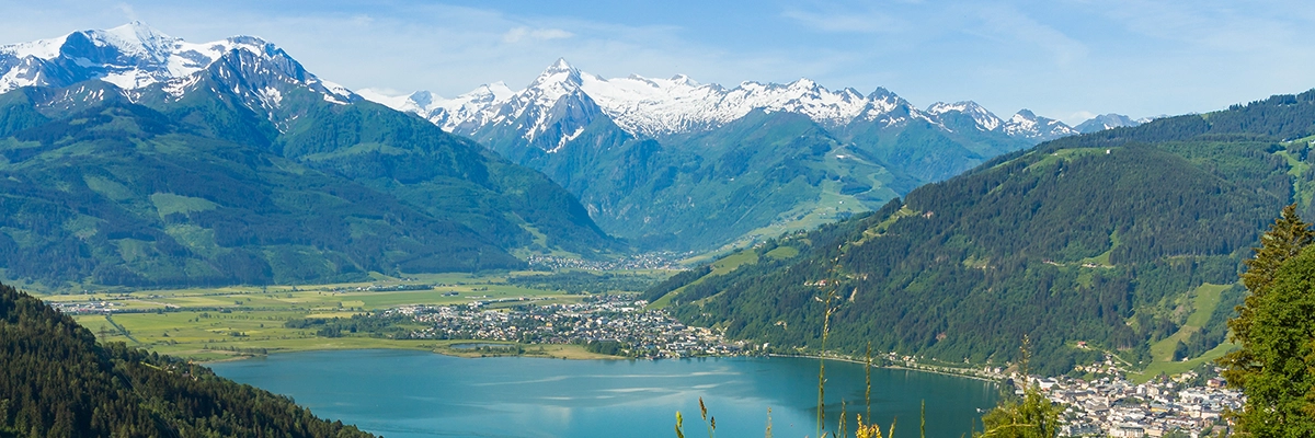 View of Lake Zell, the town of Zell am See, and snowy Kitzsteinhorn glacier in Austria, featured in the Austria destination guide