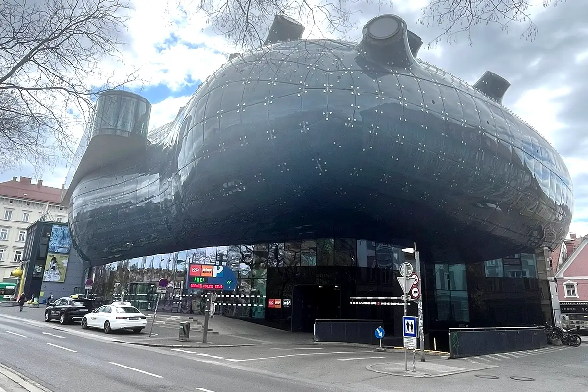 Kunsthaus Graz contemporary art museum with its futuristic blue exterior set against the historic city skyline, highlighting things to do in Graz.