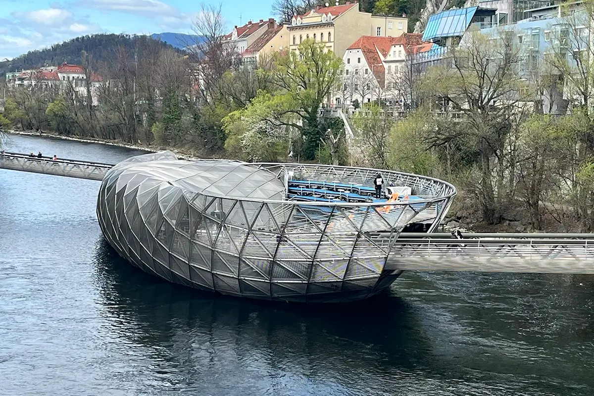 Murinsel floating platform on the Mur River in Graz during daytime with pedestrian walkways and river views