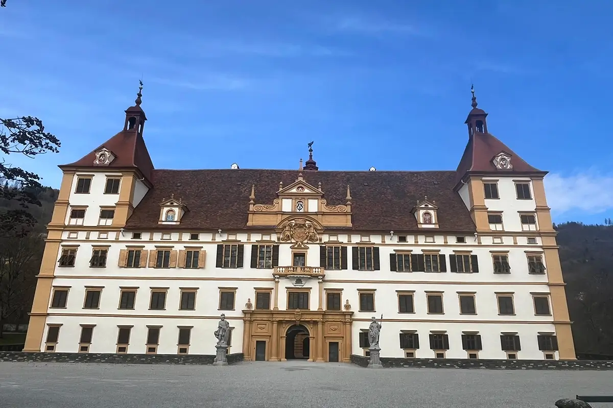 Exterior view of Schloss Eggenberg in Graz with its baroque palace architecture and formal gardens.