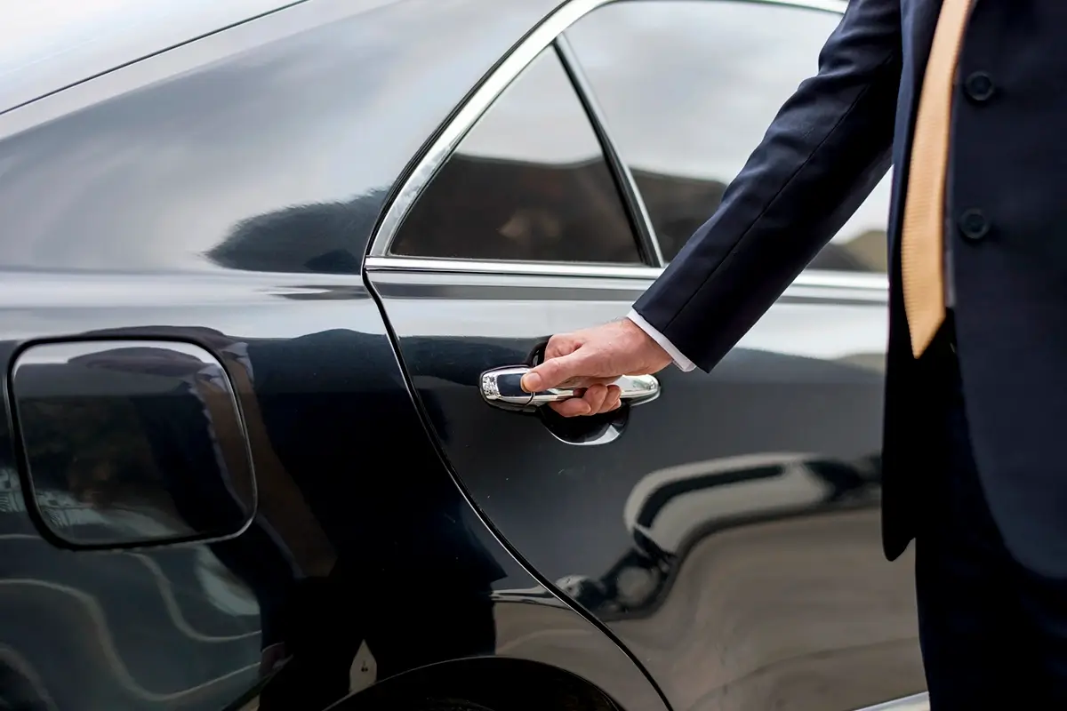 Airport or City Transfers- Chauffeur opening car door